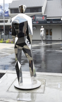 Public sculptures reflect light and dark on Cuba St